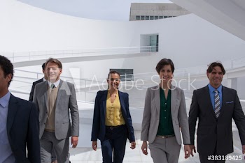 Corporate business people walking in modern courtyard