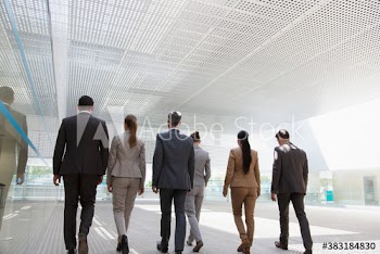 Corporate business people walking in modern office