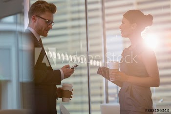 Corporate business people with coffee using smart phone in office