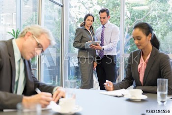 Corporate business people with digital tablet talking in office