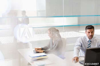 Corporate business people working at laptops in office