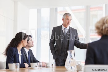 Corporate businessman leading conference room meeting