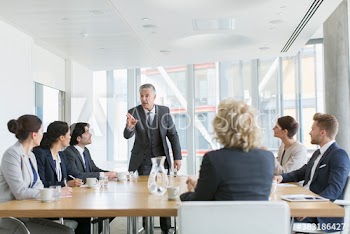 Corporate businessman leading conference room meeting