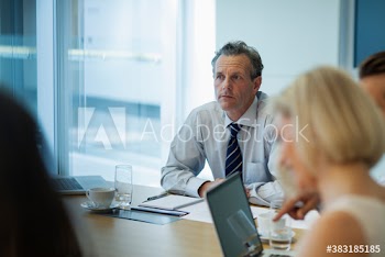 Corporate businessman listening in conference room meeting