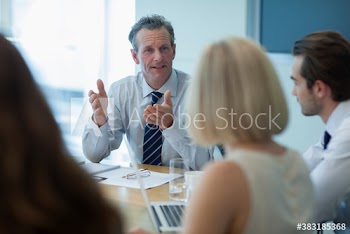 Corporate businessman talking in conference room meeting