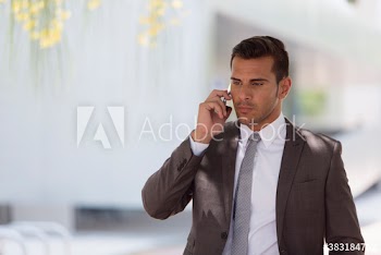 Corporate businessman talking on smart phone