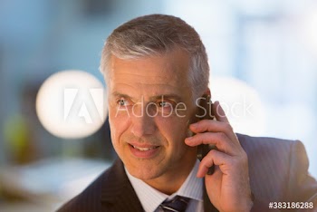 Corporate businessman talking on smart phone