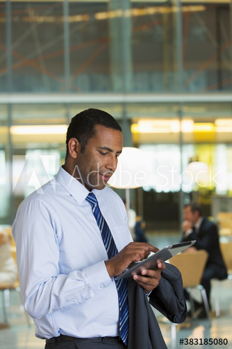Corporate businessman using digital tablet in office