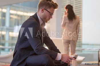 Corporate businessman using digital tablet in office