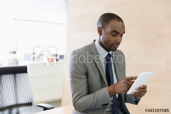 Corporate businessman using digital tablet in office