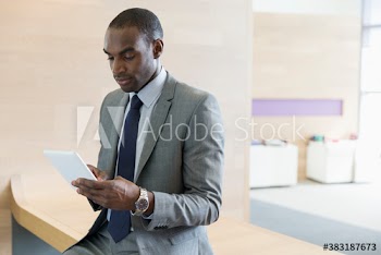 Corporate businessman using digital tablet in office