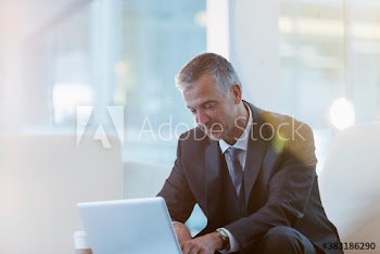 Corporate businessman using laptop