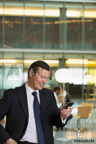 Corporate businessman using smart phone in office