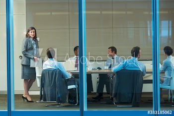 Corporate businesswoman leading conference room meeting