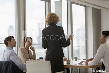 Corporate businesswoman leading conference room meeting