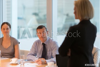 Corporate businesswoman leading conference room meeting