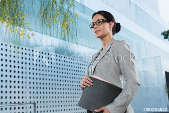Corporate businesswoman outside modern office building