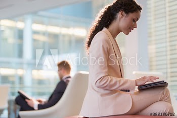 Corporate businesswoman using digital tablet in office