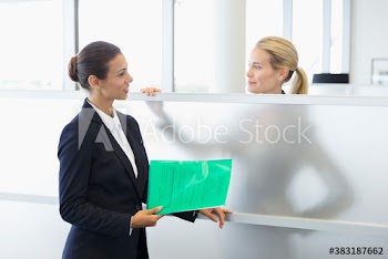 Corporate businesswomen talking in office