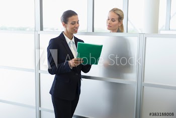 Corporate businesswomen talking in office