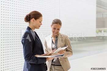 Corporate businesswomen using digital tablet