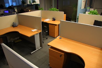 Corporate office settings showing desks, cubicles, files, and conference space
