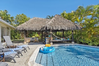 Cottage And Beach Chairs By The Pool