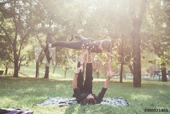 Couple doing yoga in park
