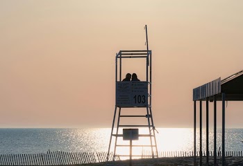 Couple Embracing at Sunset on the Beach