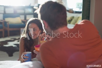 Couple enjoying breakfast in apartment
