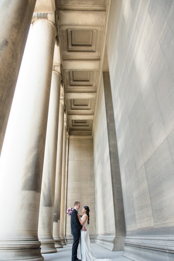 Couple Face to Face Under Gray Building