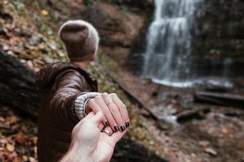 Couple Holds Hands Hiking Waterfalls