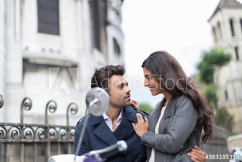 Couple hugging on scooter, Paris, France