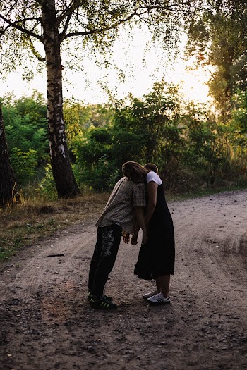 Couple Hugging While Standing on Dirtway