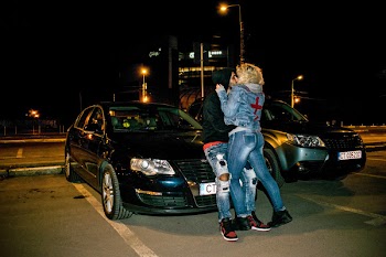 Couple Kissing Beside Black Volkswagen Passat B6 Sedan during Nighttime