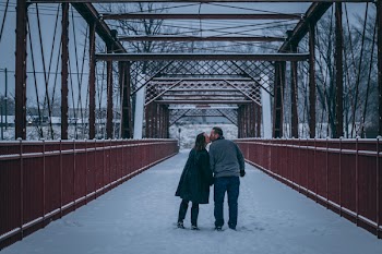 Couple Kissing on Bridge Covered With Snow