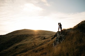 couple kissing on top of hill