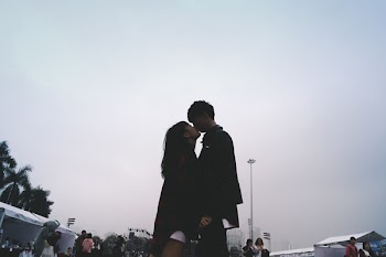 Couple Kissing Together Standing Near People
