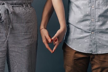 Couple Making Heart Sign With Hands