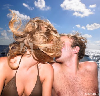 couple on kissing on yacht