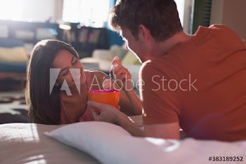 Couple sharing cereal in apartment