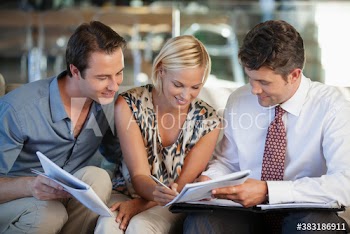 Couple signing paperwork for financial advisor