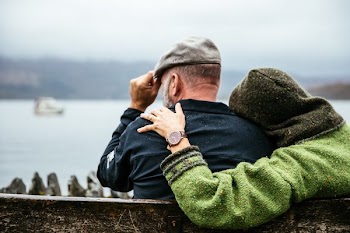 Couple Sits In British Rain