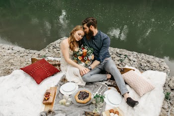 Couple Sitting Beside Calm Body of Water