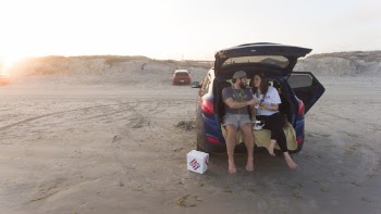Couple Sitting on Car Boot