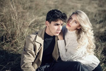 Couple Sitting on Grass Field