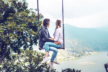 Couple Sitting on Swing