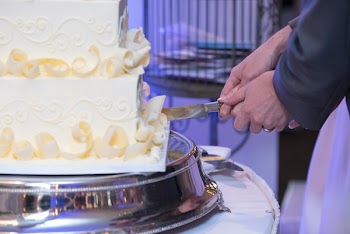 Couple Slicing Cake