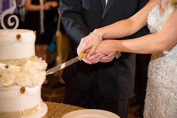 Couple Slicing Wedding Cake