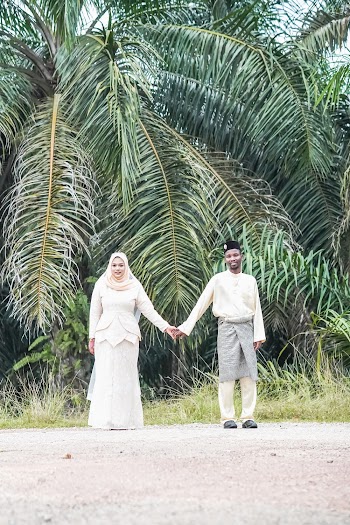 Couple Standing Beside Coconut Trees